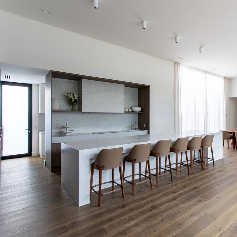 Open-plan kitchen with marble island in a Balwyn home plumbed by Scotland Marshall Plumbing