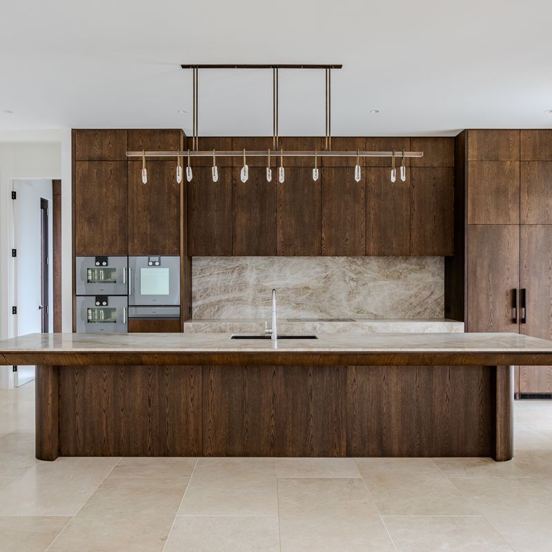 Kitchen with stone benchtop and island sink in a Hawthorn home plumbed by Scotland Marshall Plumbing