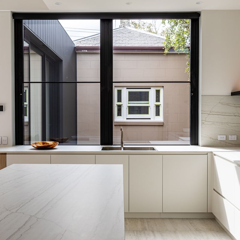 Kitchen with stone benchtops and double sink in a Windsor home plumbed by Scotland Marshall Plumbing